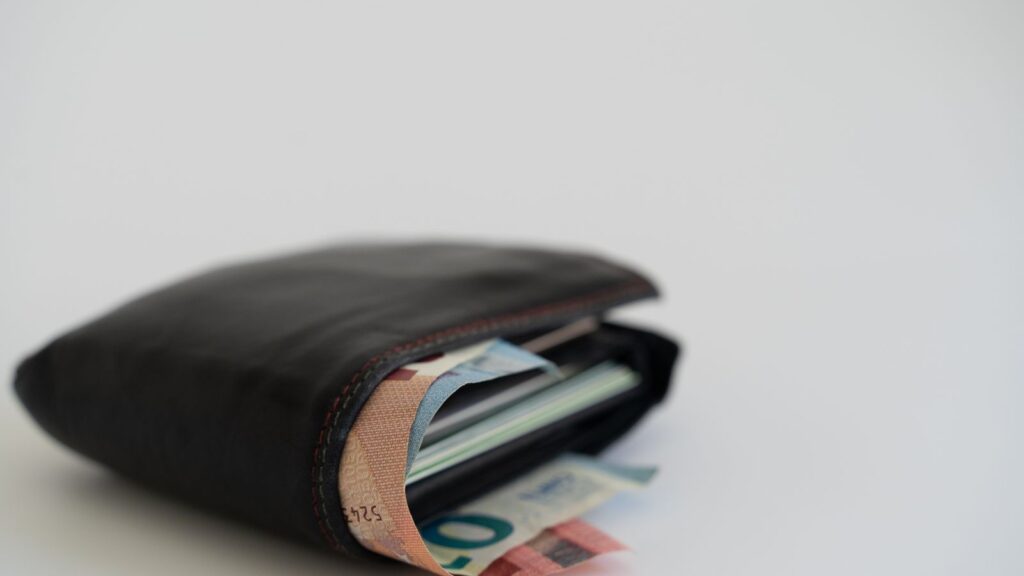 Open wallet representing a small casino deposit
